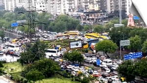 Heavy rainfall in Noida led to severe traffic disruptions, waterlogging, and vehicles crawling on the road